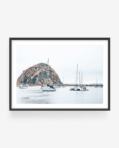 Framed fine art photograph of Morro Bay harbor with sailboats and Morro Rock in a black frame, California coastal wall art print