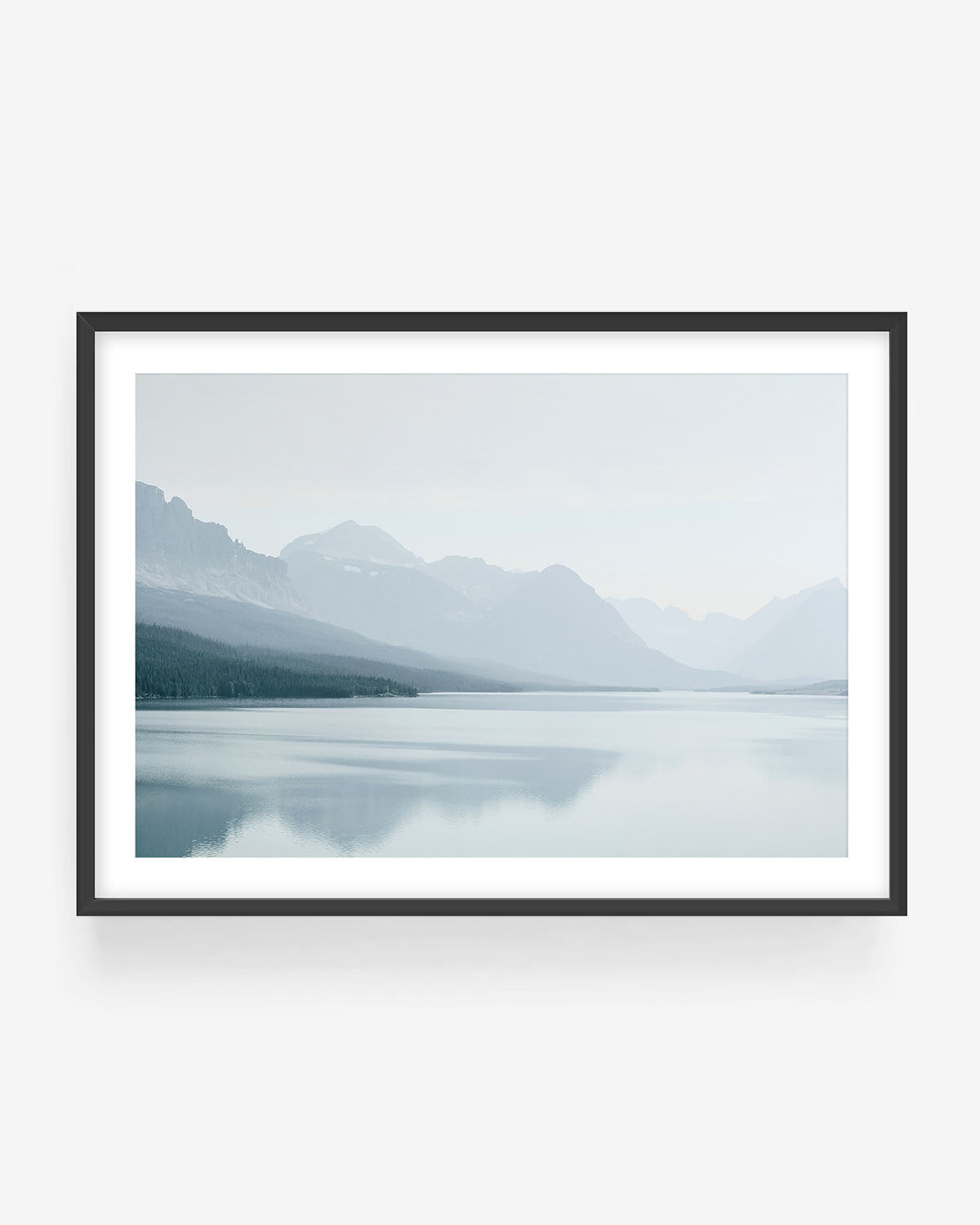 Lake Tahoe photography in black frame showing misty mountains reflected in calm lake water, minimalist landscape wall art print.