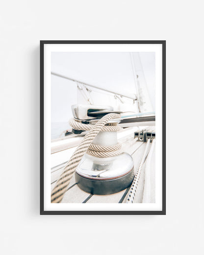 Fine art sailboat rope and winch photograph in a black frame featuring nautical deck details with coiled lines and soft coastal light.