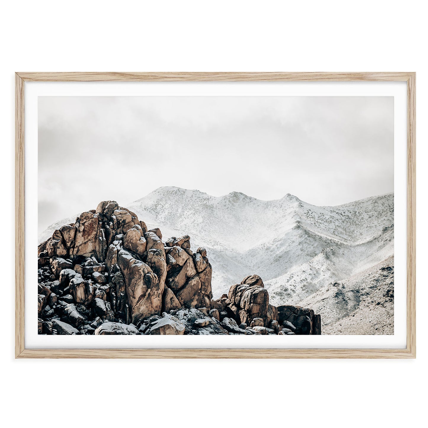 Framed winter landscape photo of Joshua Tree National Park with soft golden desert light rugged rock formations and iconic Joshua trees in a tranquil setting