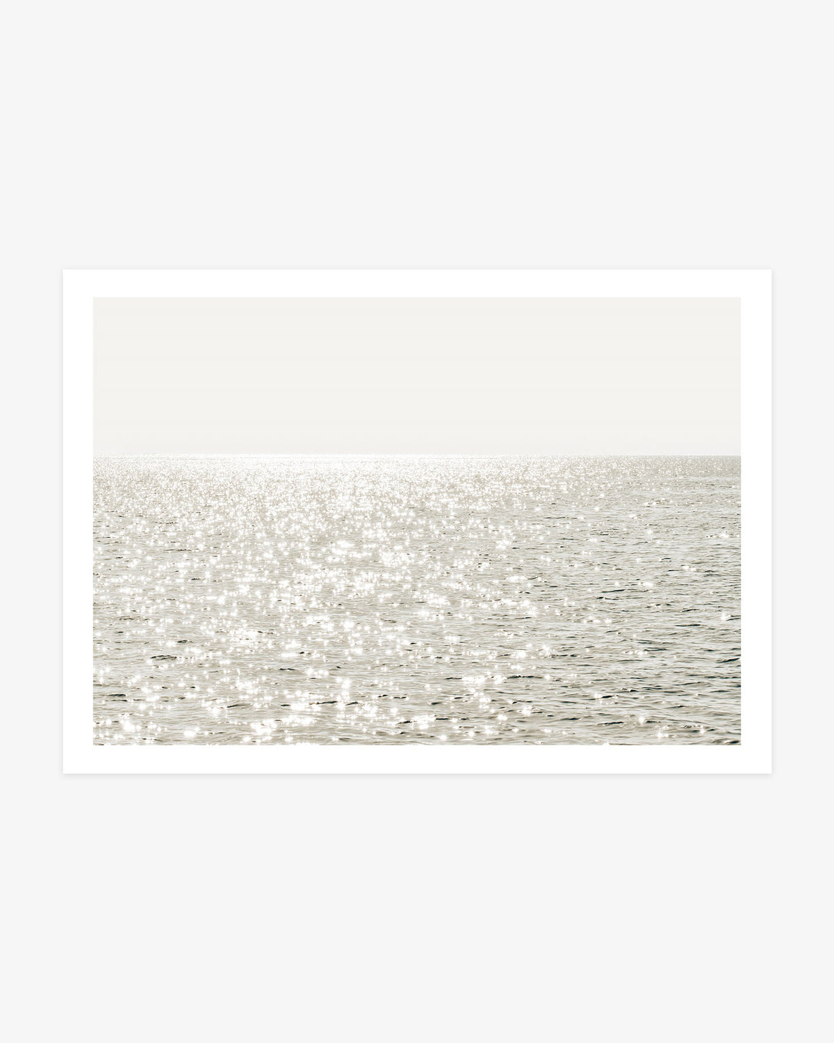 Minimalist ocean wall art featuring bright sunlight shimmering across calm Pacific water beneath a soft, high-key horizon.