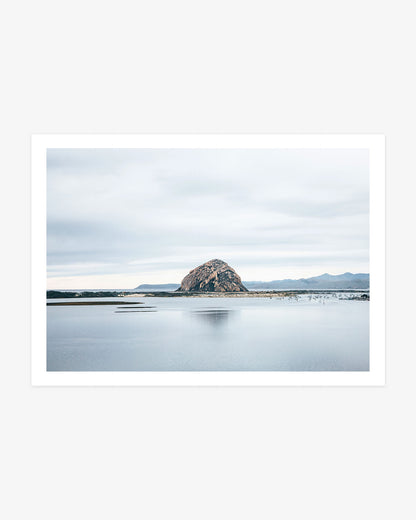 Morro Bay wall art featuring iconic Morro Rock across calm harbor water with small boats, distant hills and a softly clouded California sky.
