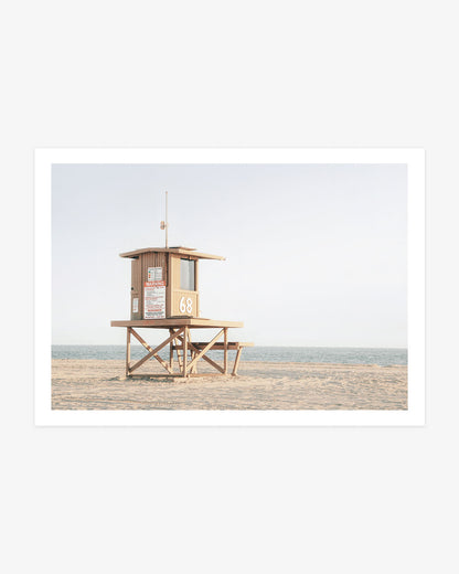 Newport Beach lifeguard tower photography featuring Tower 68 on a wide sandy shore beside the blue Pacific Ocean.