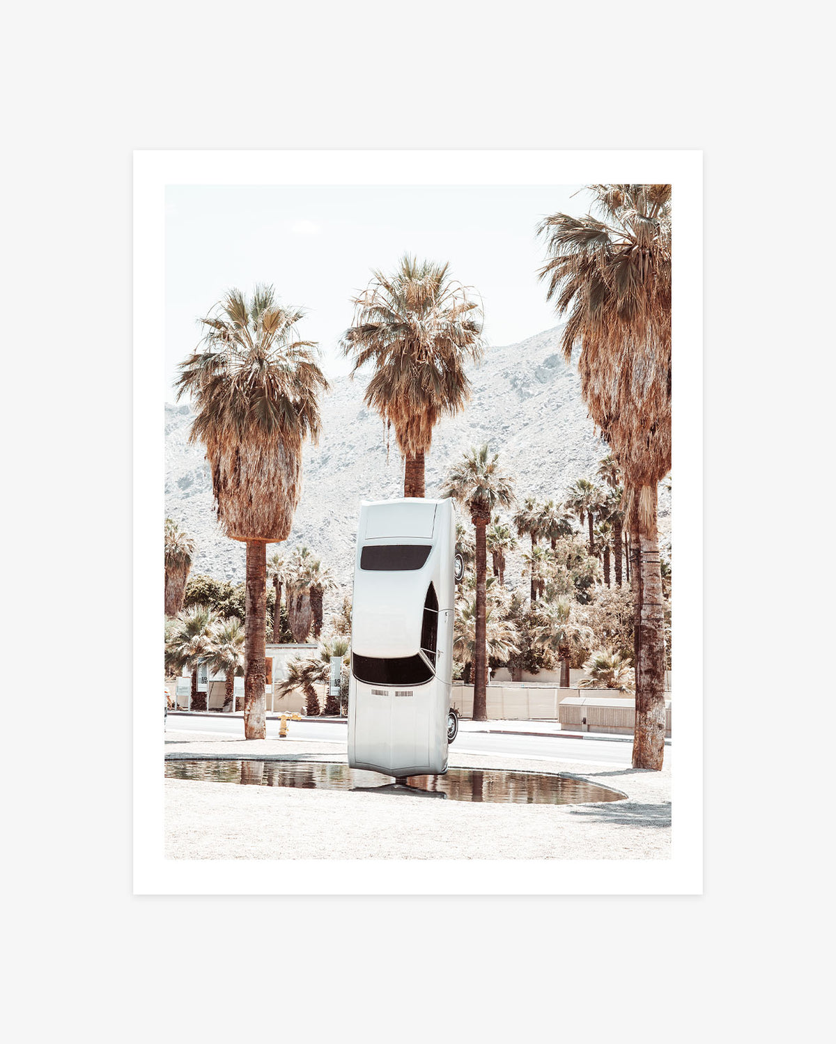 History of Suspended Time art installation in Palm Springs featuring a suspended vintage car surrounded by palm trees and desert mountains.