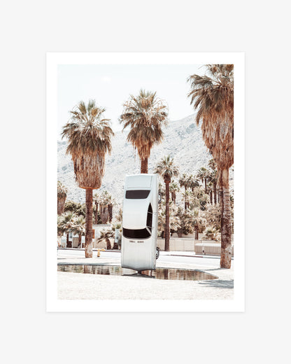 History of Suspended Time art installation in Palm Springs featuring a suspended vintage car surrounded by palm trees and desert mountains.