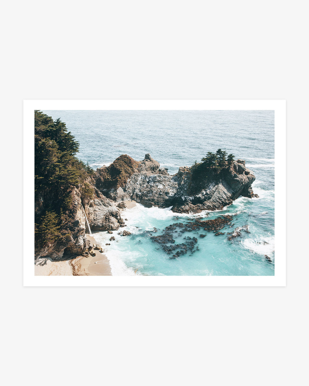 McWay Falls photography featuring the Big Sur waterfall flowing onto a secluded sandy cove surrounded by rugged cliffs, cypress trees and turquoise Pacific water.
