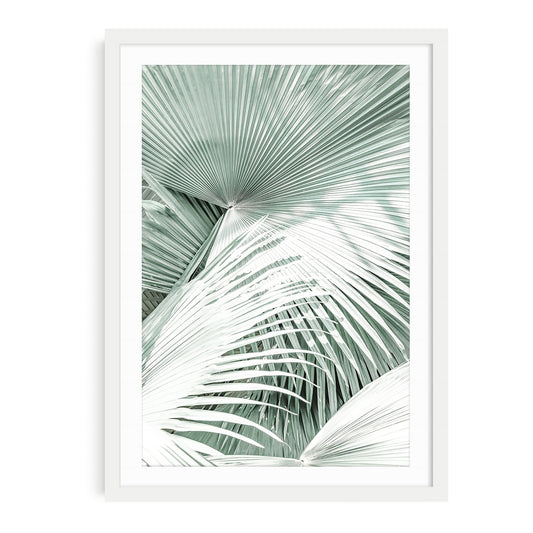 Framed boho palm tree wall art featuring soft mint green tones and tropical foliage in a minimalist coastal photography style, perfect for beach decor.