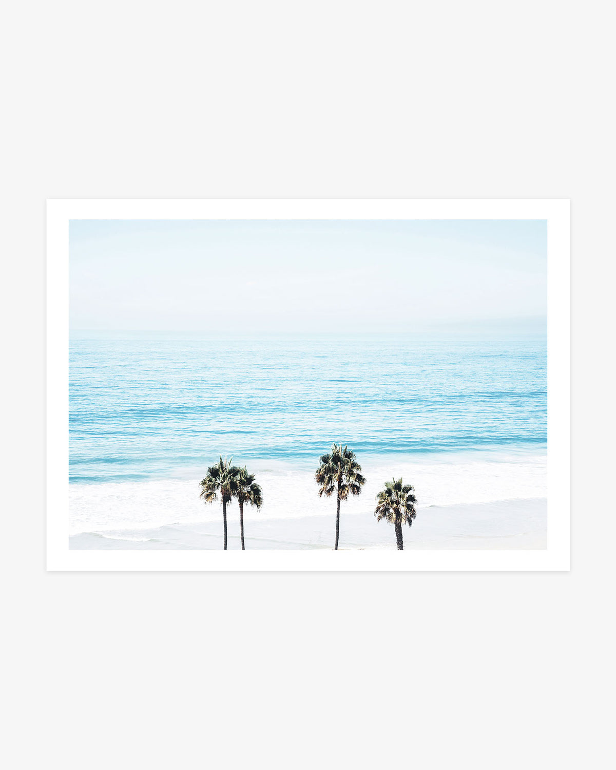 San Clemente wall art featuring three palm trees beneath a wide view of the turquoise Pacific Ocean in soft blue coastal tones.