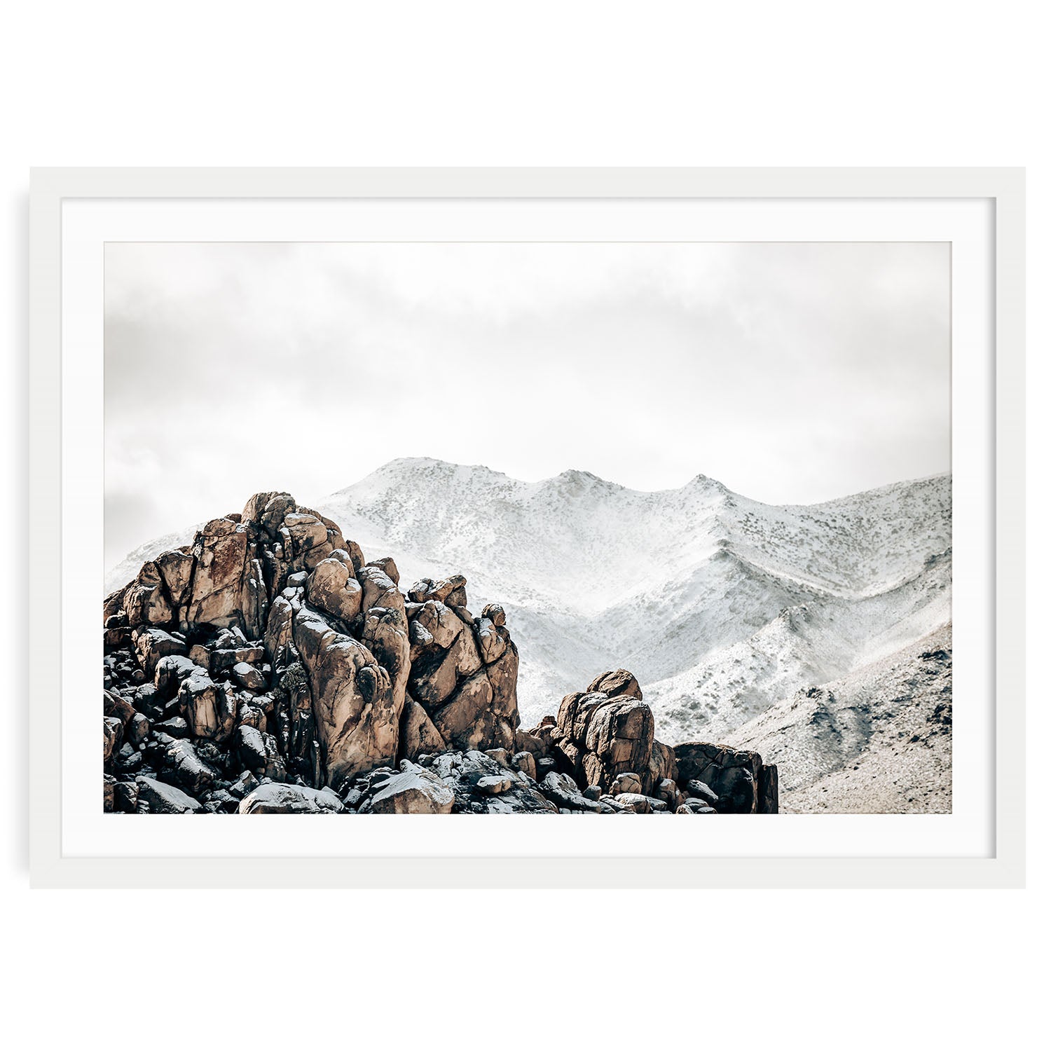Framed winter landscape photo of Joshua Tree National Park with soft golden desert light rugged rock formations and iconic Joshua trees in a tranquil setting