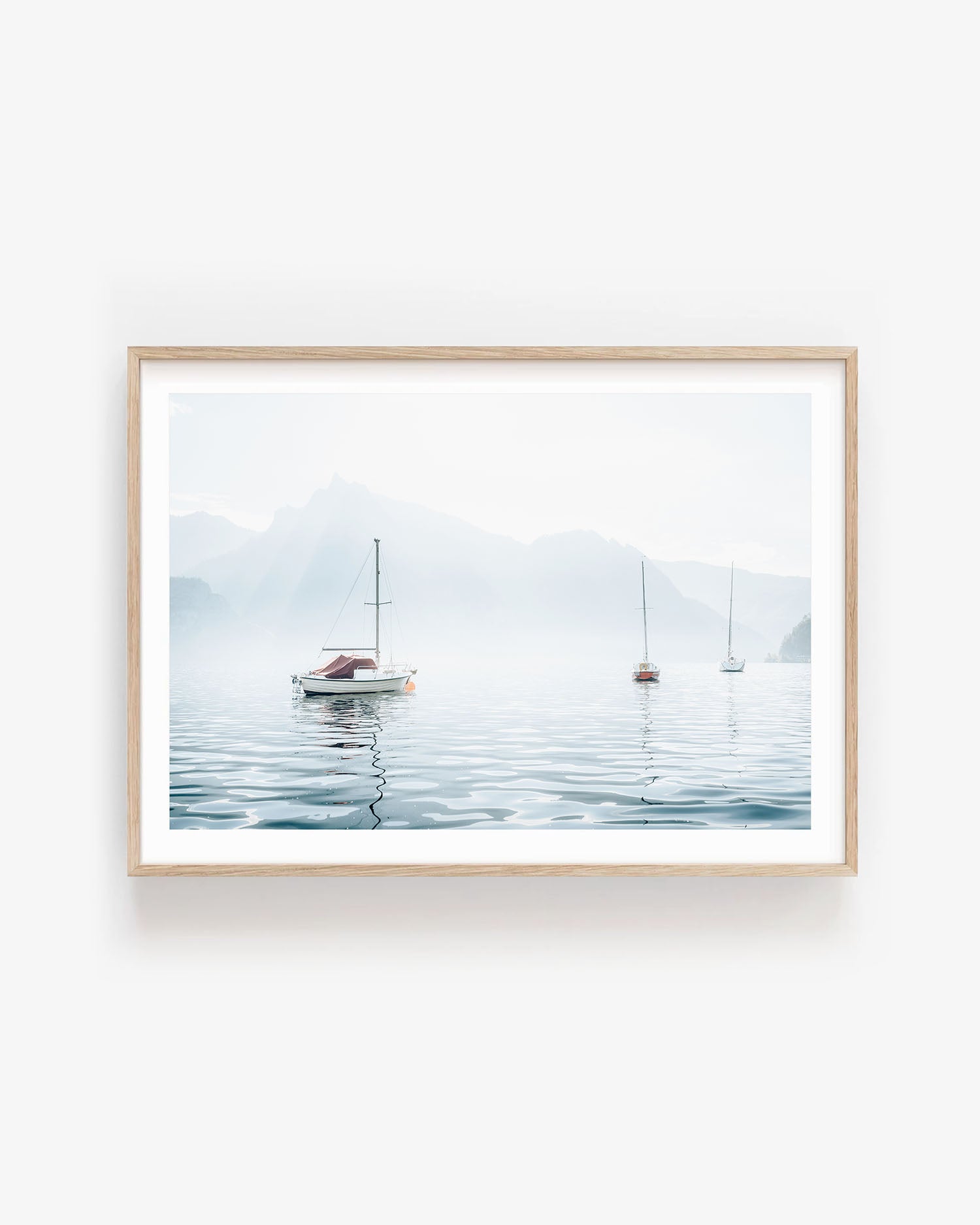 Minimalist nautical wall art featuring sailboats on a calm lake with pastel blue sky, perfect for coastal inspired or serene home decor themes.
