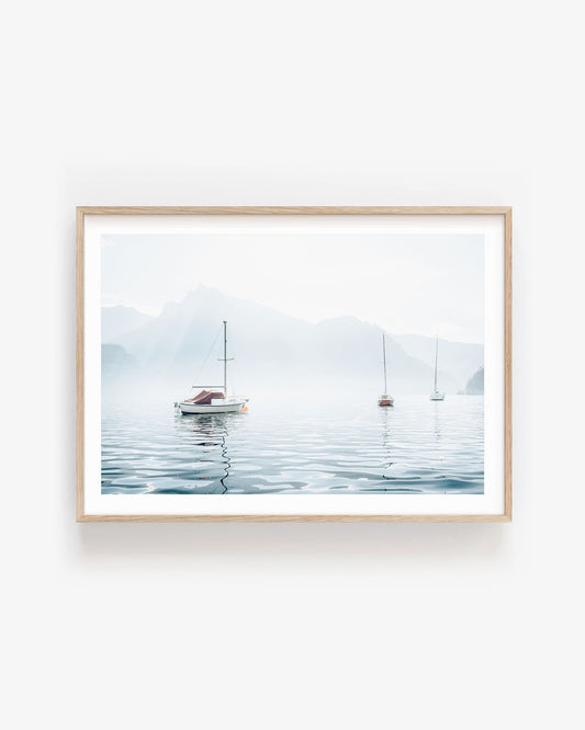 Minimalist nautical wall art featuring sailboats on a calm lake with pastel blue sky, perfect for coastal inspired or serene home decor themes.