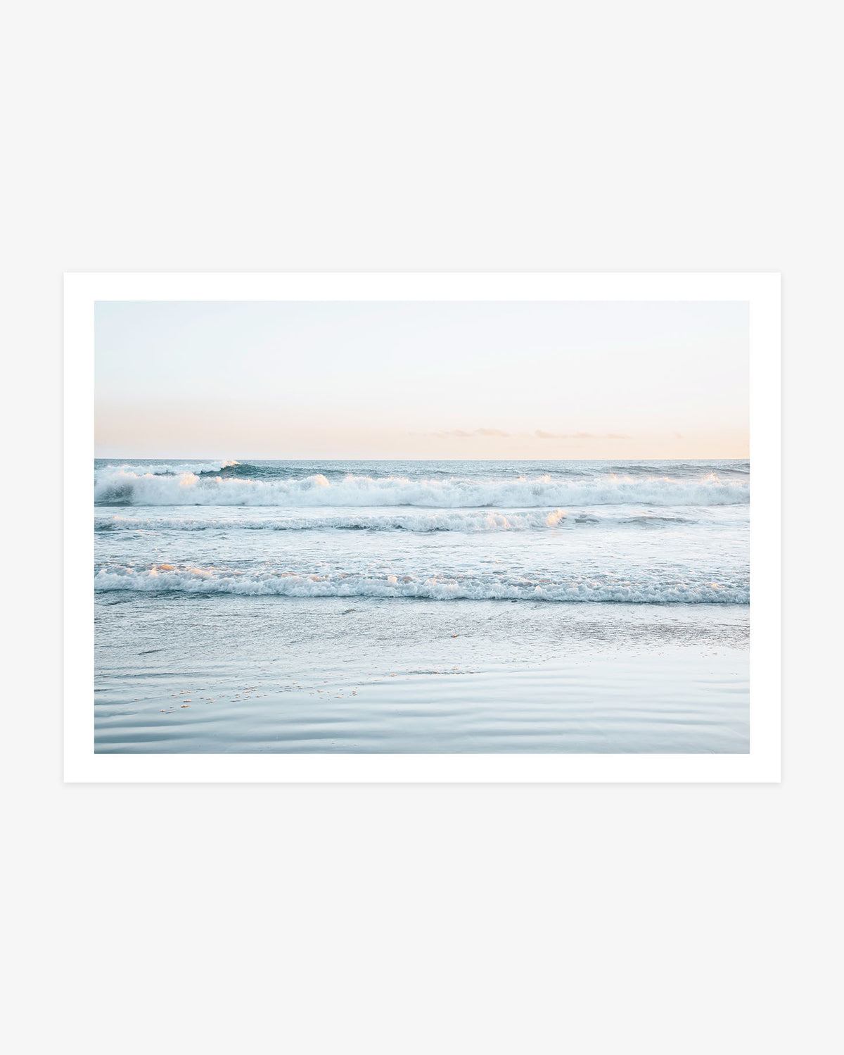 Dana Point ocean wall art featuring layered Pacific waves, reflective wet sand and a soft blue and peach coastal sky.