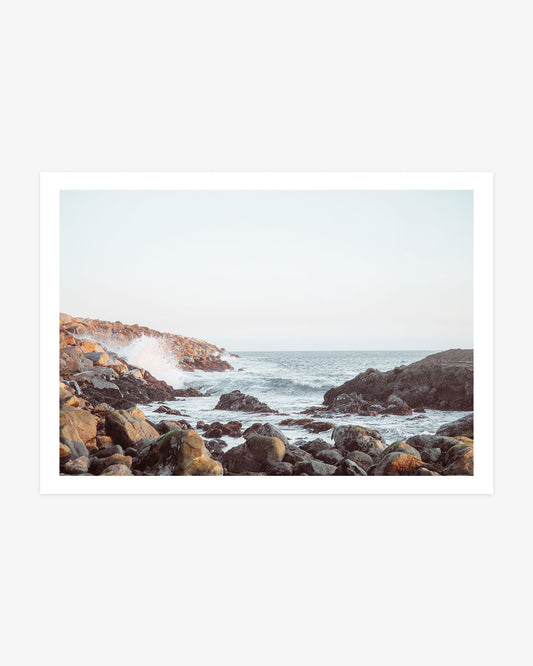 Dana Point coastal wall art featuring Pacific waves breaking through a rocky inlet beneath a pale blue Southern California sky