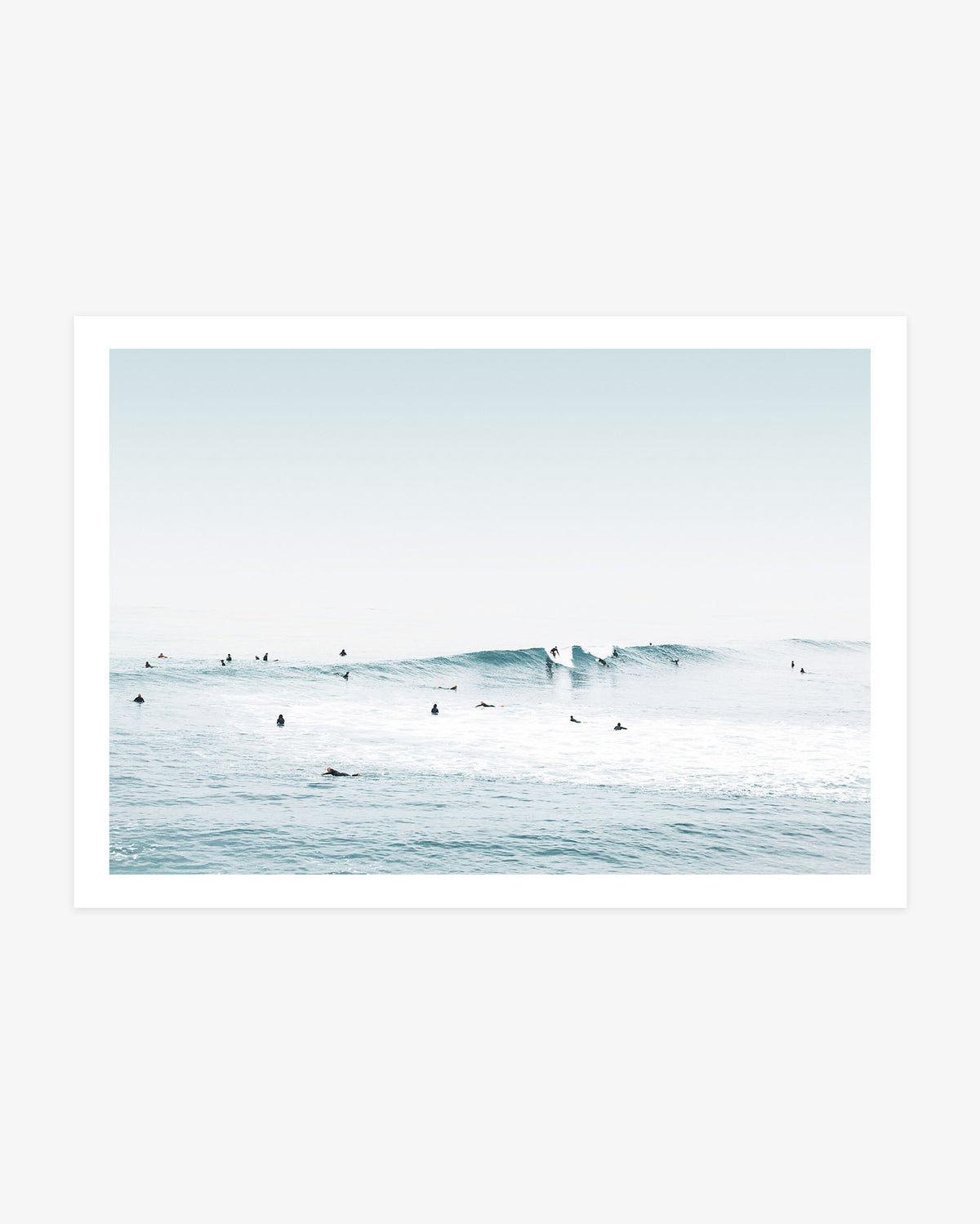 Huntington Beach surf wall art featuring two surfers riding a clean blue wave as others wait across the calm Pacific water.