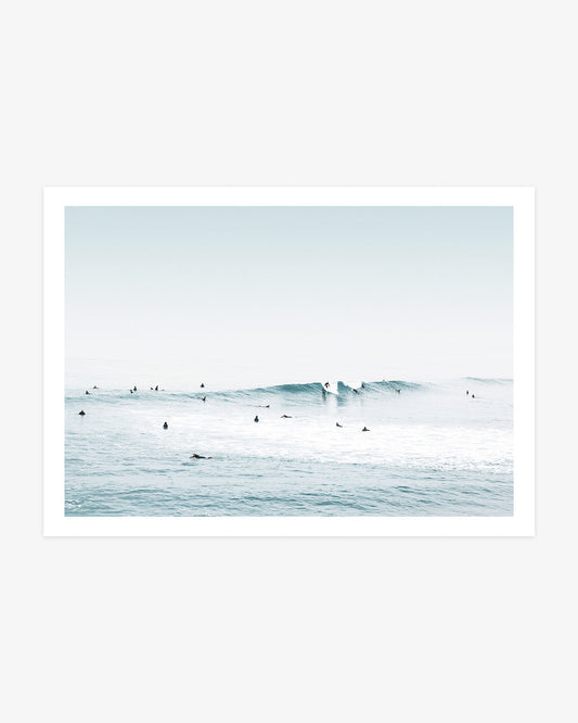 Huntington Beach surf wall art featuring two surfers riding a clean blue wave as others wait across the calm Pacific water.
