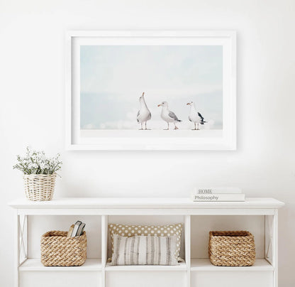 Three seagulls standing on the beach in soft neutral tones wall art print
