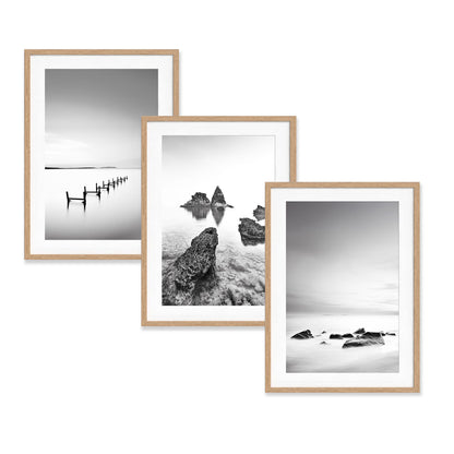 Minimalist black and white coastal photography print in a natural wood frame