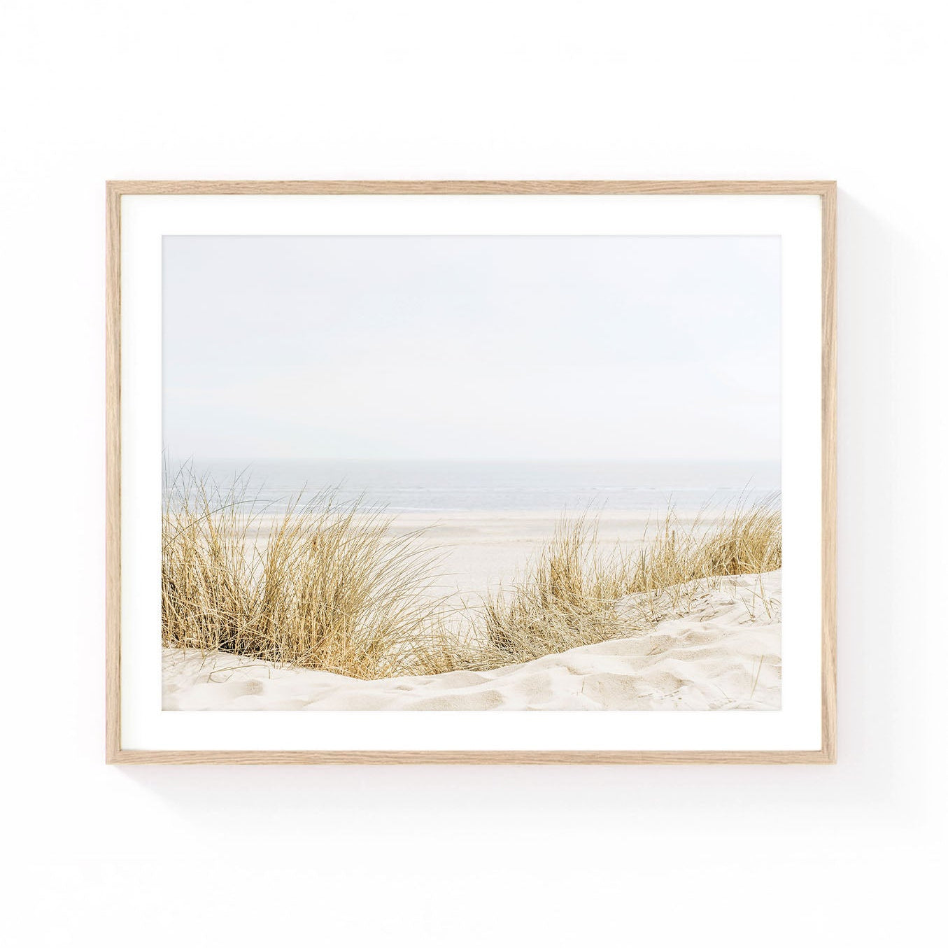 Beach dune wall art featuring soft golden dune grass, sandy coastal dunes, and a tranquil ocean horizon in airy neutral tones.
