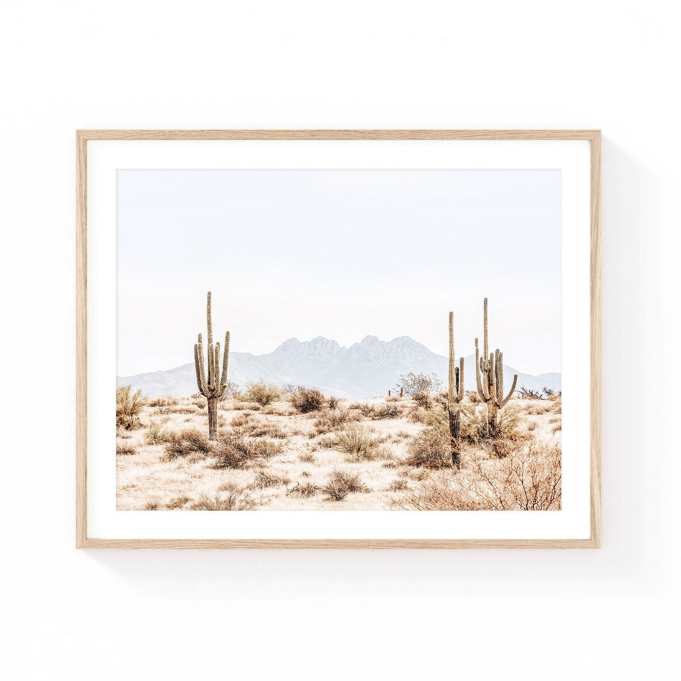 Arizona desert wall art featuring towering saguaro cacti with the Four Peaks mountain range in the distance, captured in soft neutral desert tones.