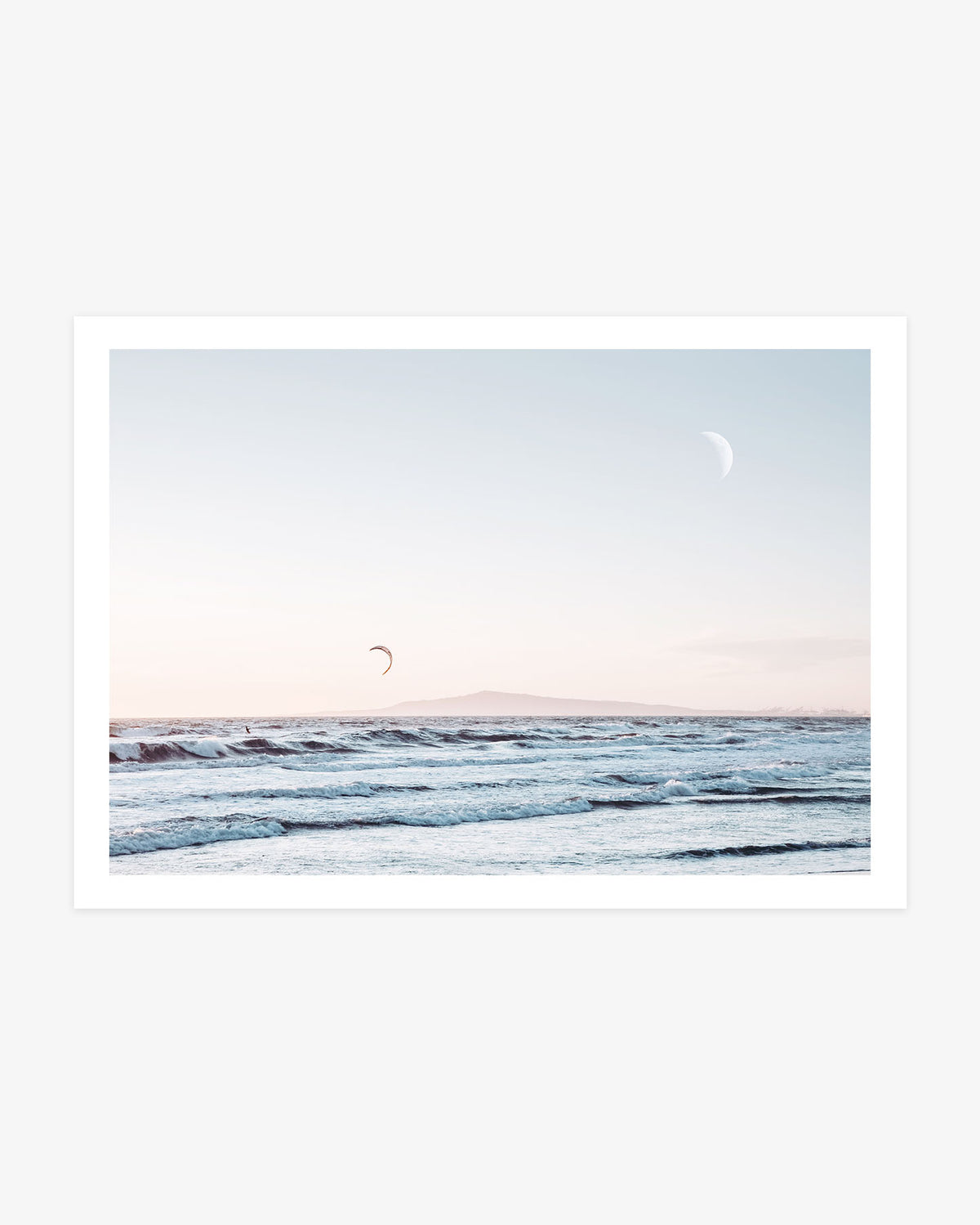 Huntington Beach wall art featuring a crescent moon above rolling Pacific waves, a distant kitesurfer and Catalina Island on the horizon.