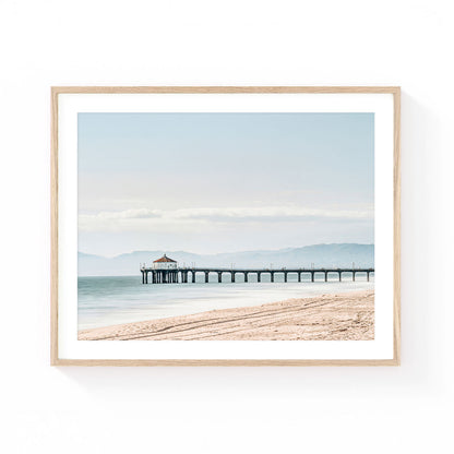 Manhattan Beach Pier wall art featuring the historic California pier stretching into the Pacific Ocean with soft blue coastal tones and sandy shoreline.