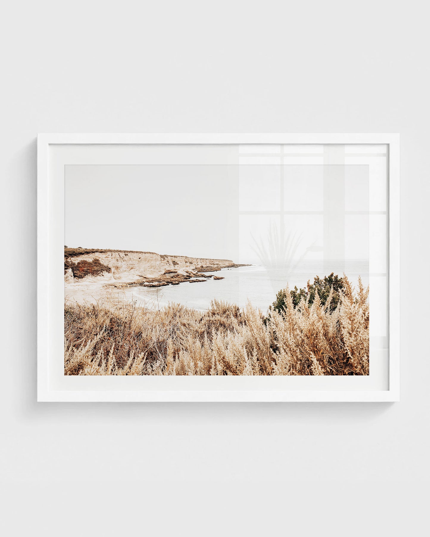 Montana de Oro coastal cliffs with dry golden grasses overlooking a calm ocean under a soft neutral sky.