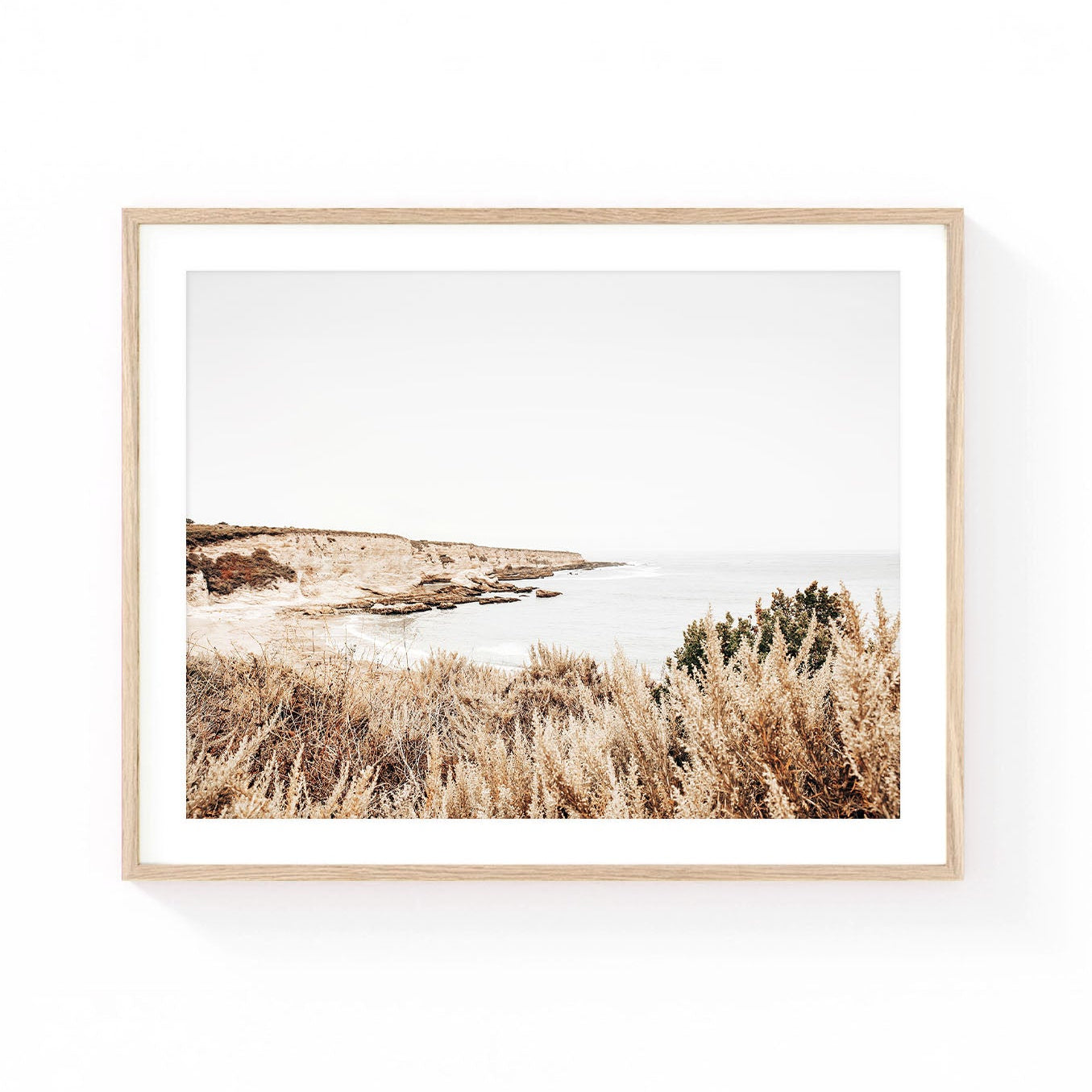 Montaña de Oro wall art featuring rugged coastal cliffs, calm ocean waters, and native California coastal brush in soft neutral earth tones.