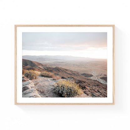 Montezuma Valley wall art featuring a sweeping desert mountain overlook with rocky terrain, golden wildflowers, distant valley landscapes, and soft sunset light.