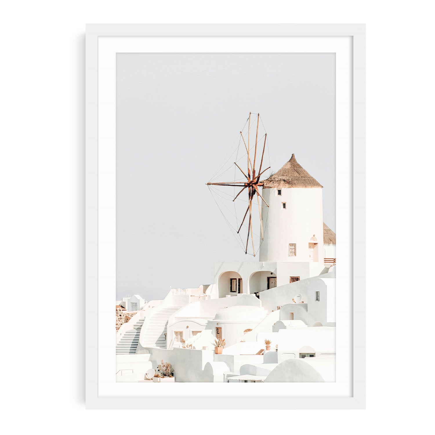 Fine art Santorini art print in white frame and mat against neutral background