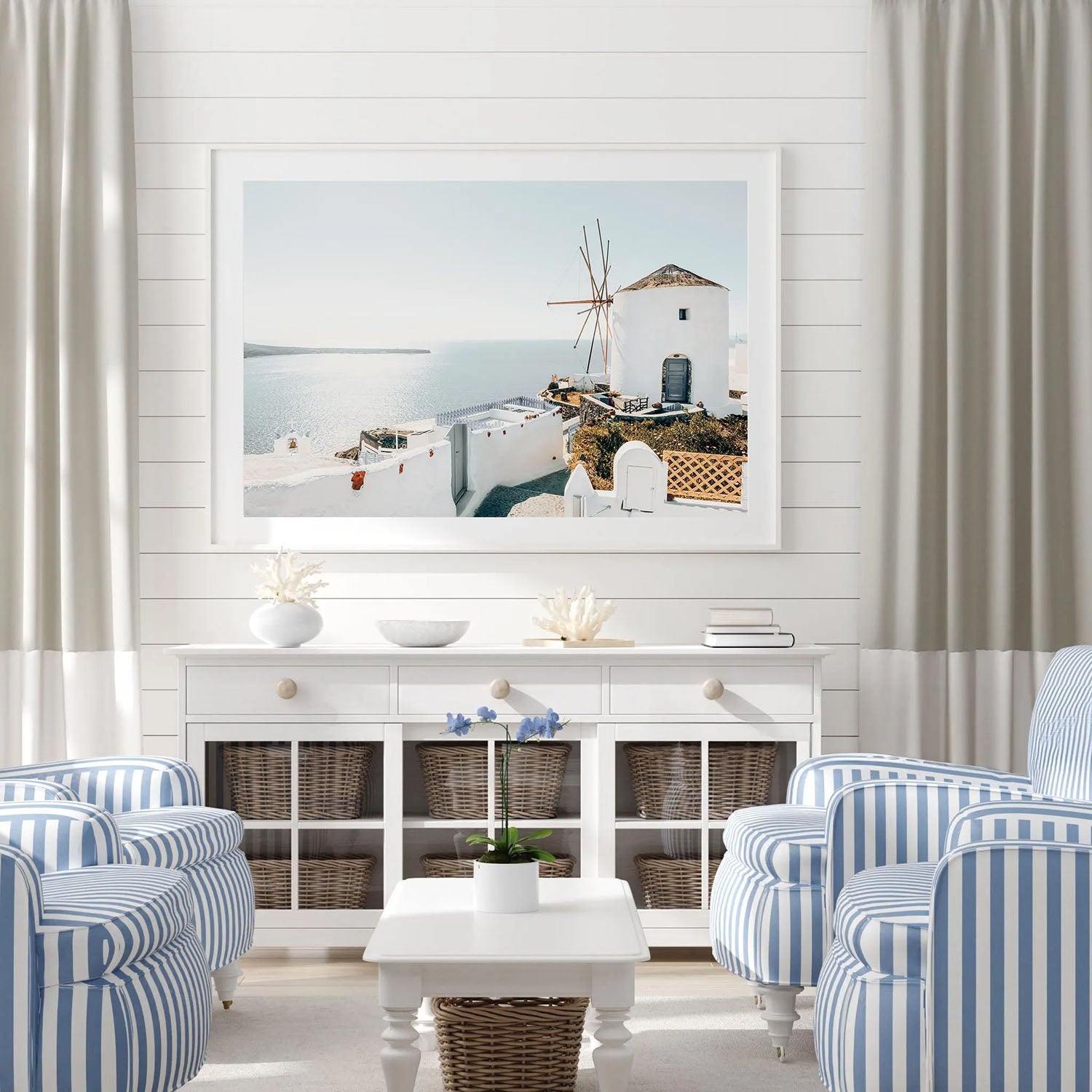 Santorini coastal wall art framed and displayed on a living room wall, styled with modern minimalist decor