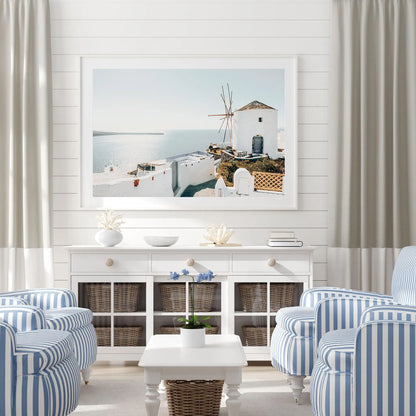 Santorini coastal wall art framed and displayed on a living room wall, styled with modern minimalist decor