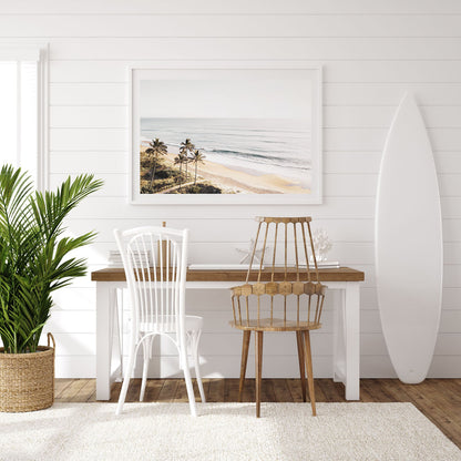 Tropical beach wall art in living room setting with muted palm and soft ocean horizon, minimalist decor