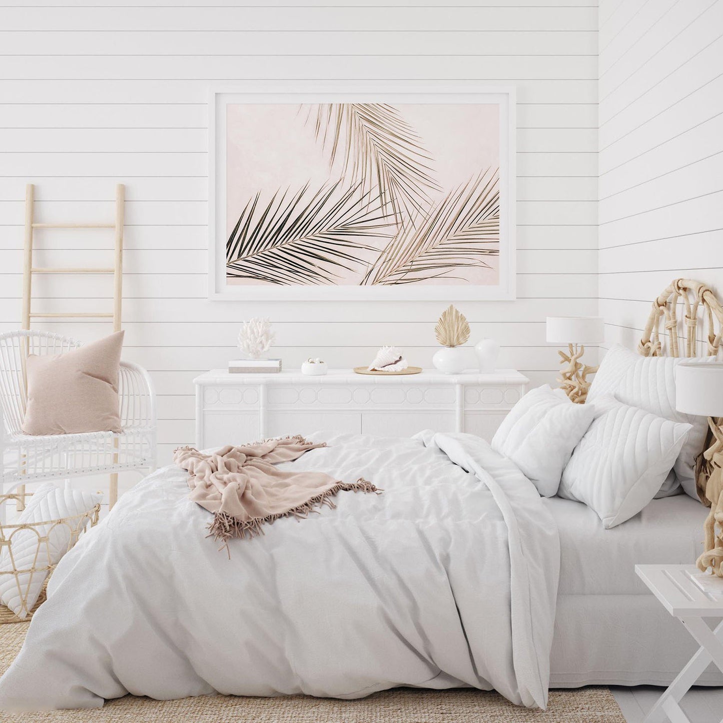Tropical palm leaves wall art print with blush background framed on a bedroom wall, styled as modern decor.